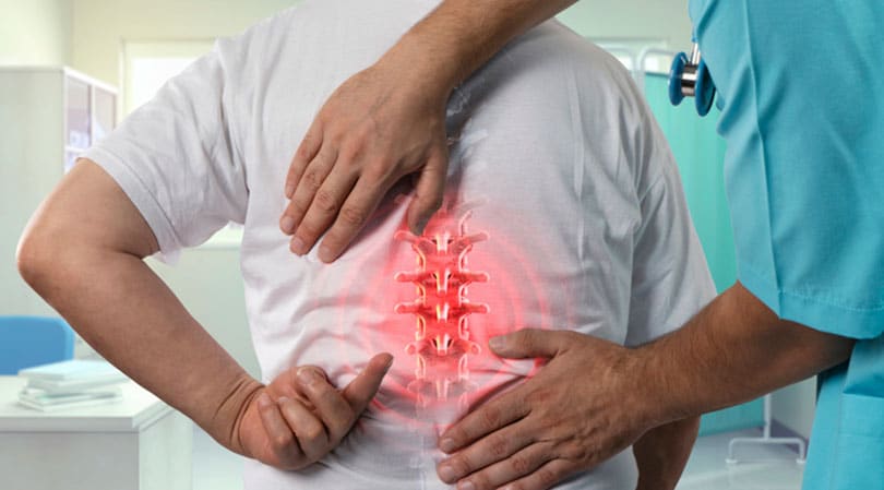 Patient Showing Doctor Back Pain And Needs Regenerative Medicine Treatment