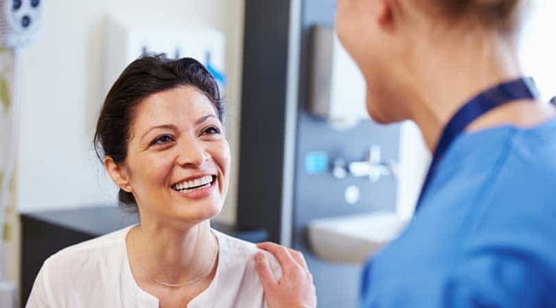 Smiling Woman Patient with Medical Doctor