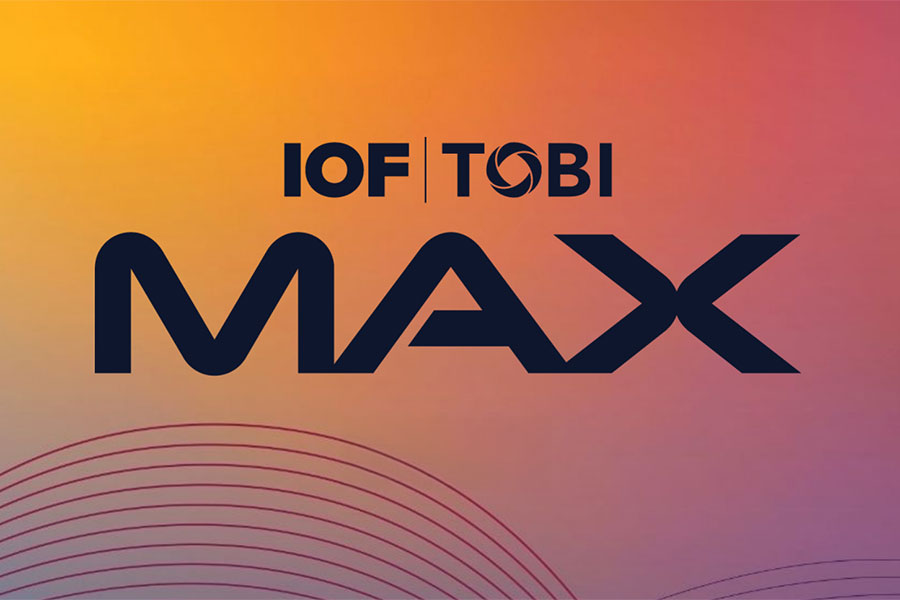 Logo with text IOF | TOBI MAX in bold black letters on a yellow-to-purple gradient background, featuring curved line patterns below—ideal branding for TOBI Conference or IOF MAX events led by Dr. Nabity.