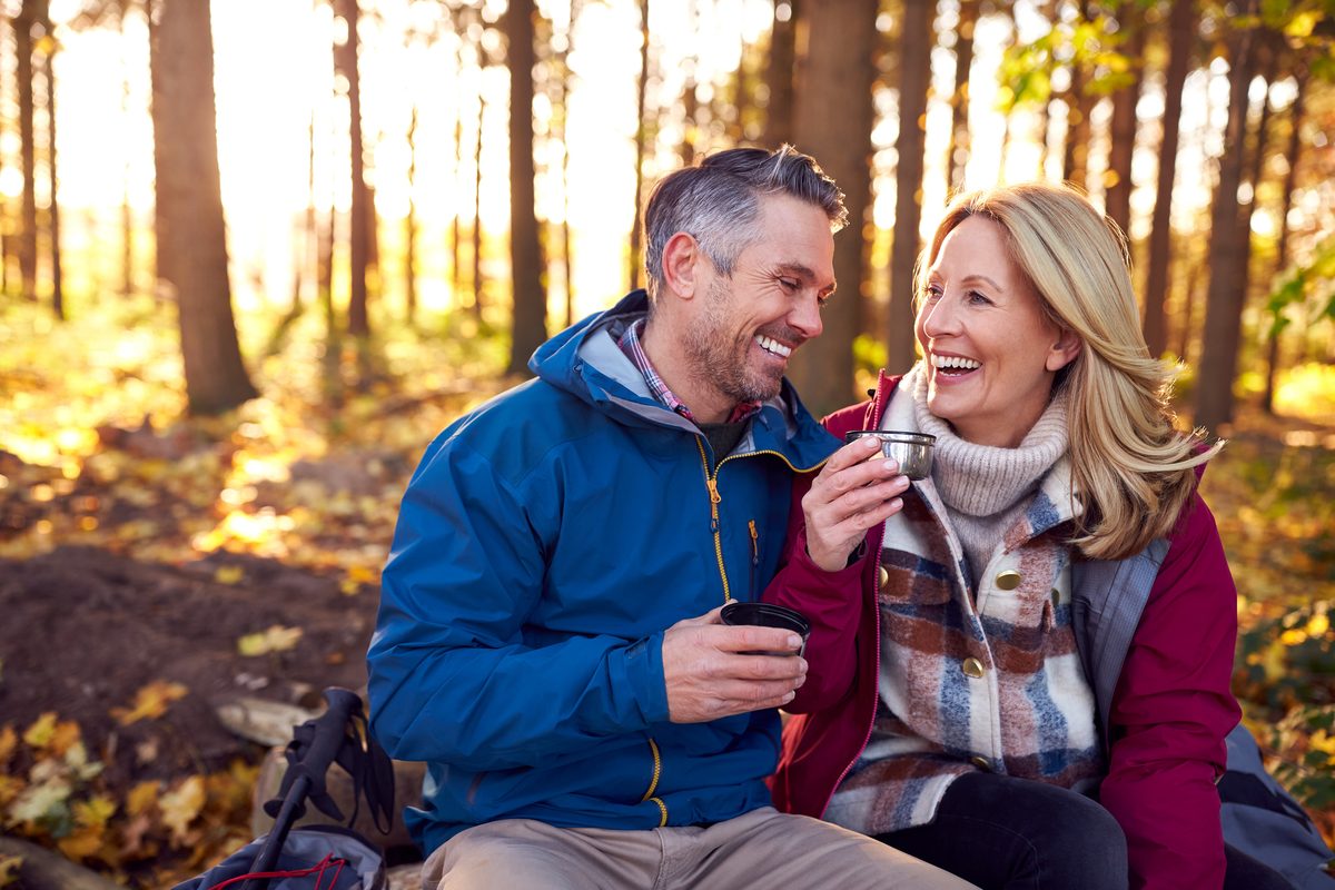 Couple sharing coffee during an autumn hike