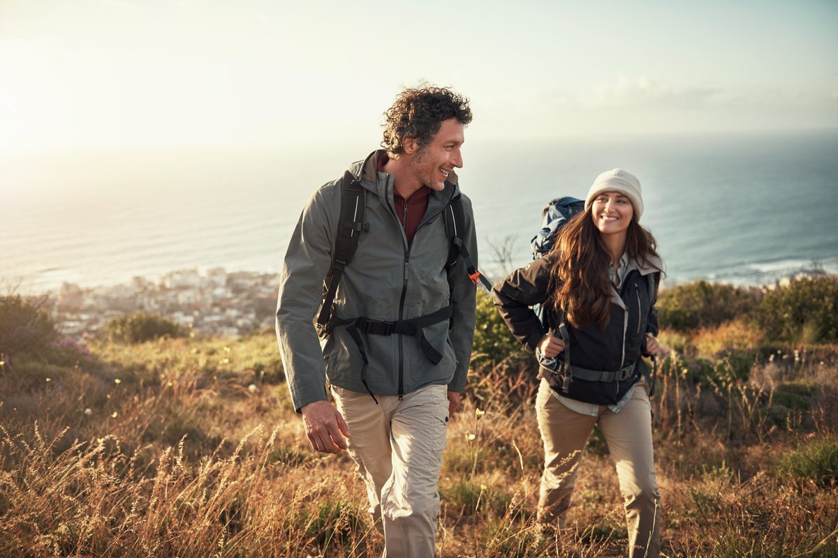 Couple hiking a coastal hillside