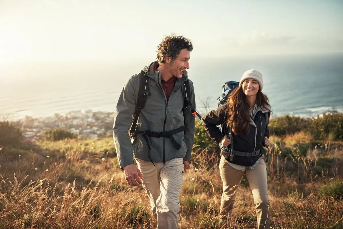Couple hiking a coastal hillside