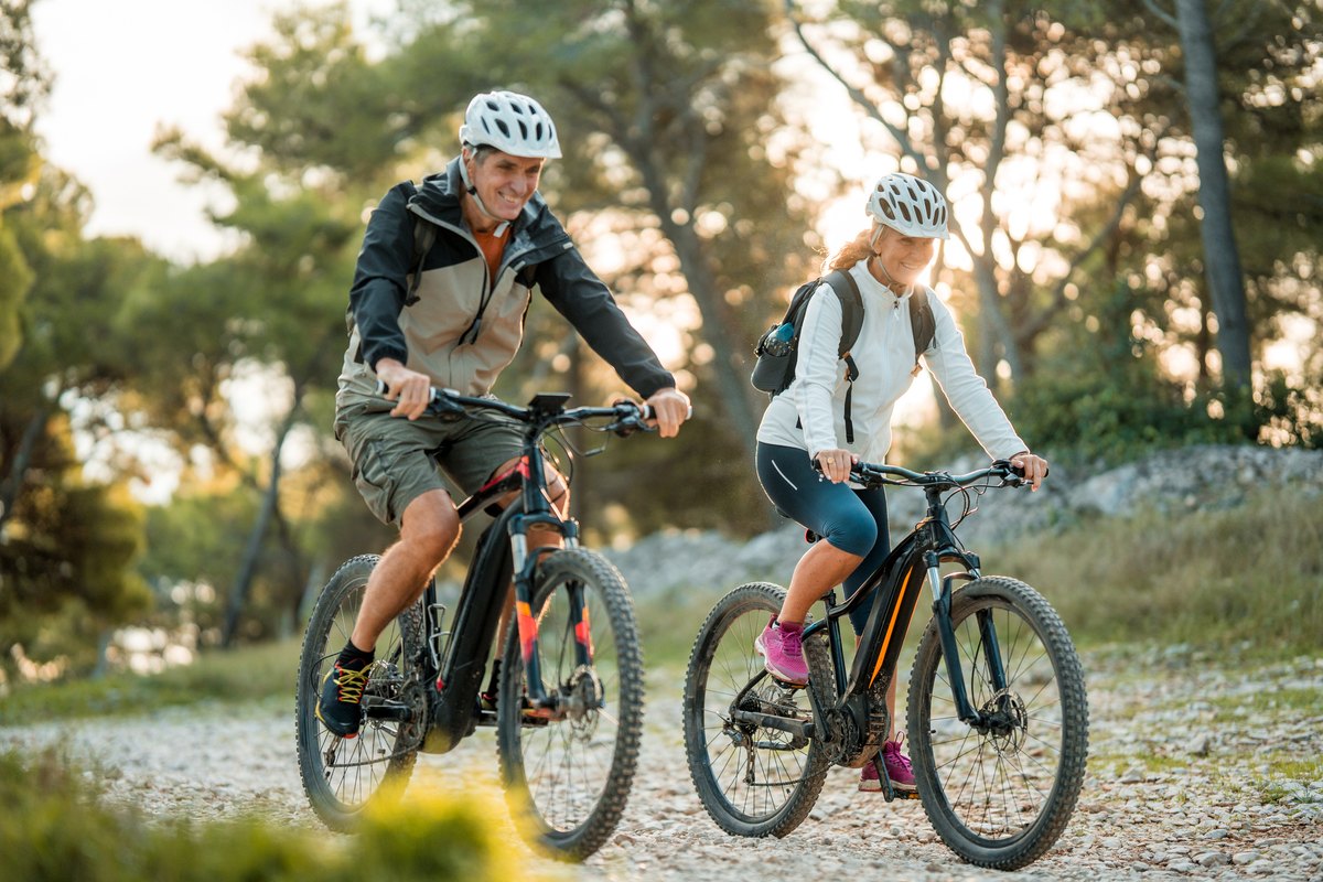 Couple riding mountain bikes