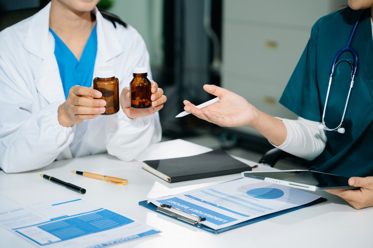 Doctor showing supplement bottles during a consultation