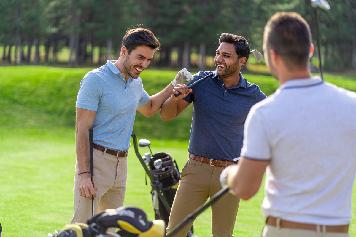 Friends laughing on a golf course