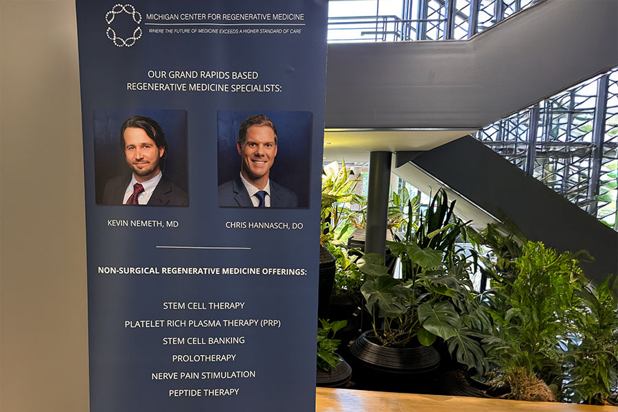 Banner for the Michigan Center for Regenerative Medicine featuring Grand Rapids physician Dr. Kevin Nemeth and Dr. Chris Hannasch, listing treatments like stem cell therapy, platelet rich plasma therapy, and nerve pain stimulation.