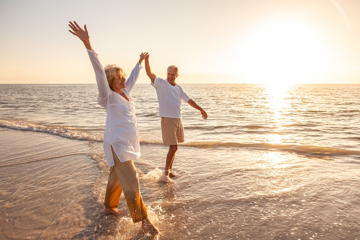 Senior couple dancing together on a beach