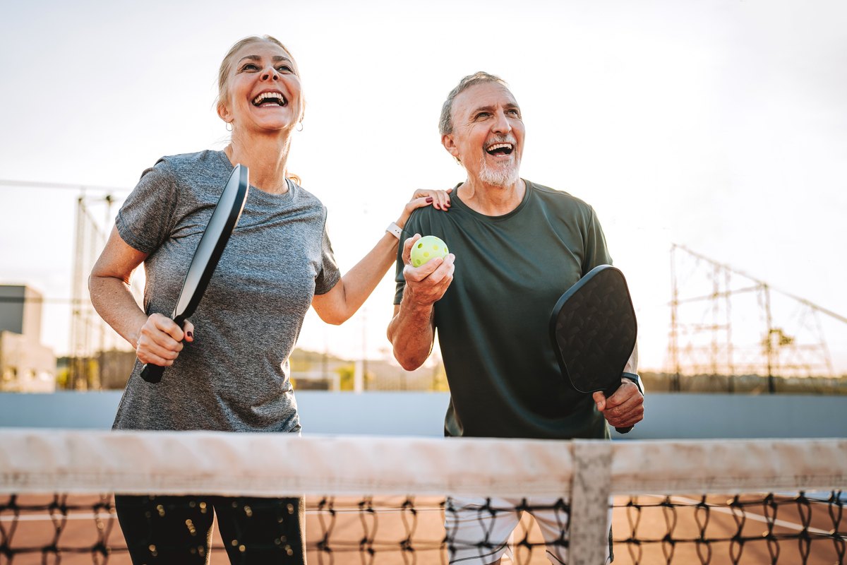 Senior couple playing pickleball
