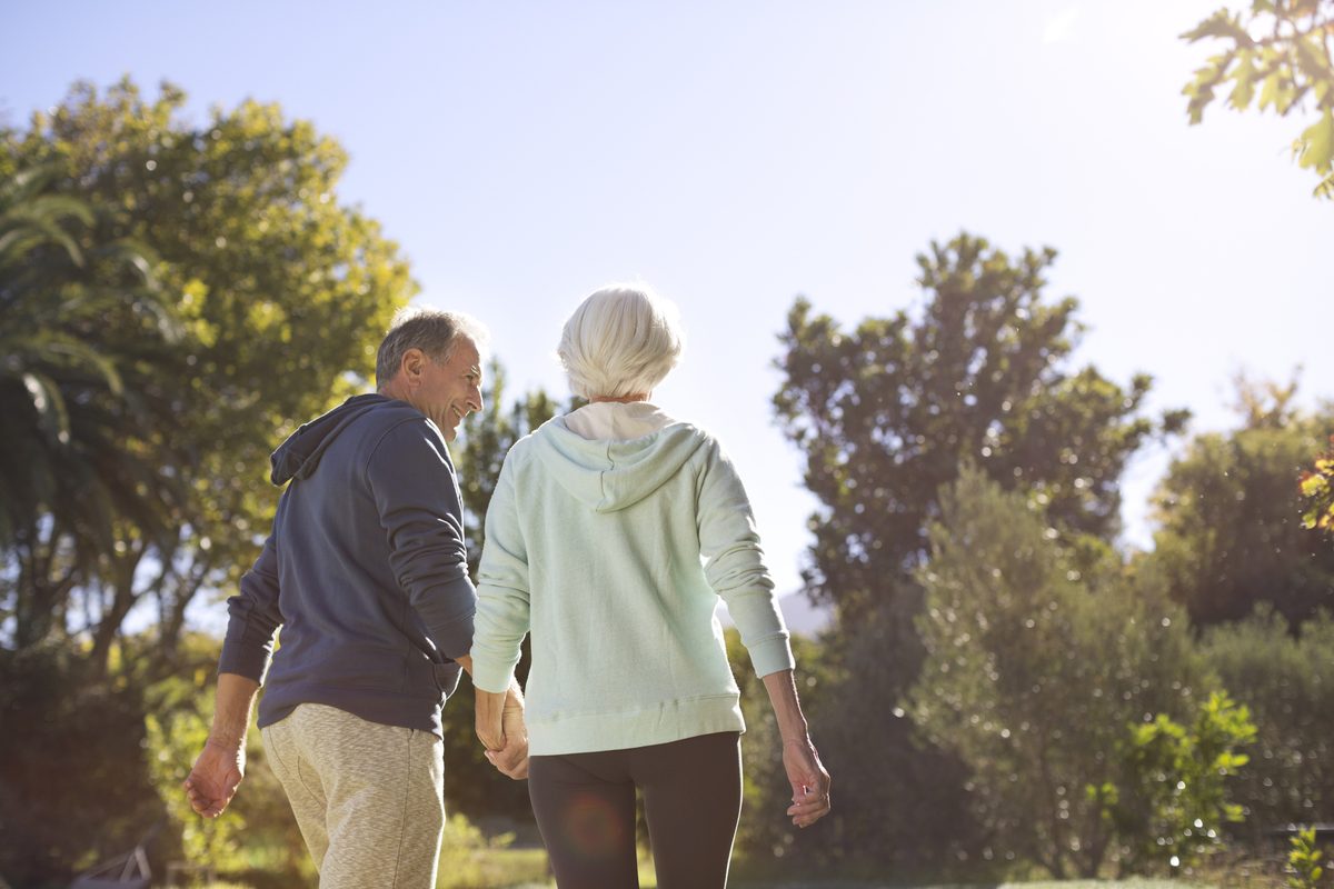 Senior couple walking in the sunshine