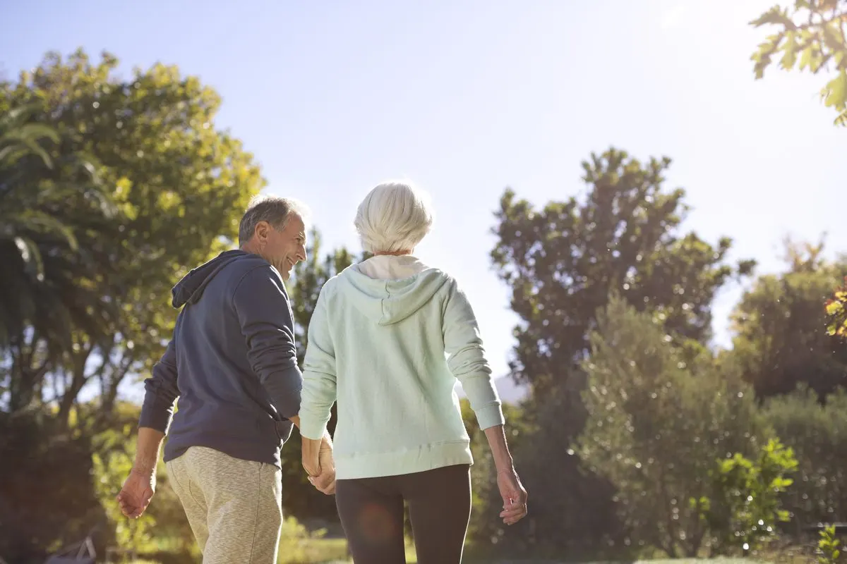 Senior couple walking in the sunshine