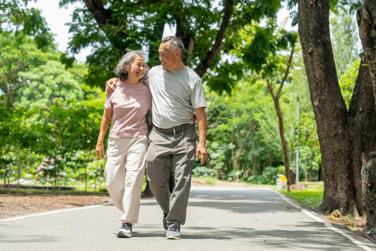 Senior couple walking a park path