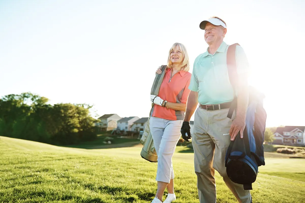 Senior couple walking to the green