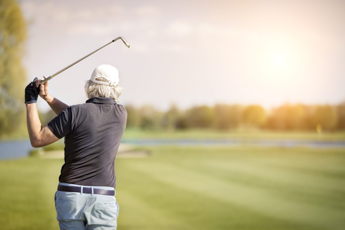 Senior golfer in the follow-through