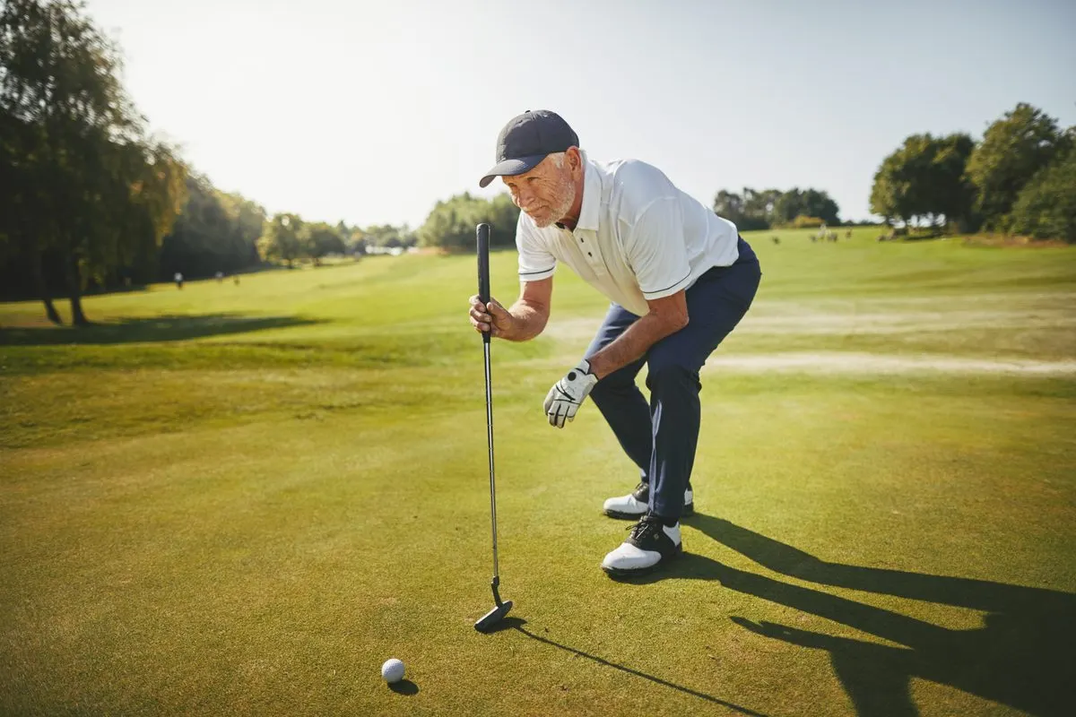 Senior golfer lining up a putt