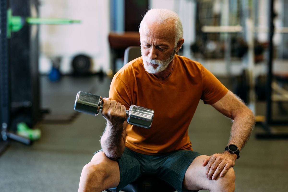 Senior man lifting a dumbbell during a workout