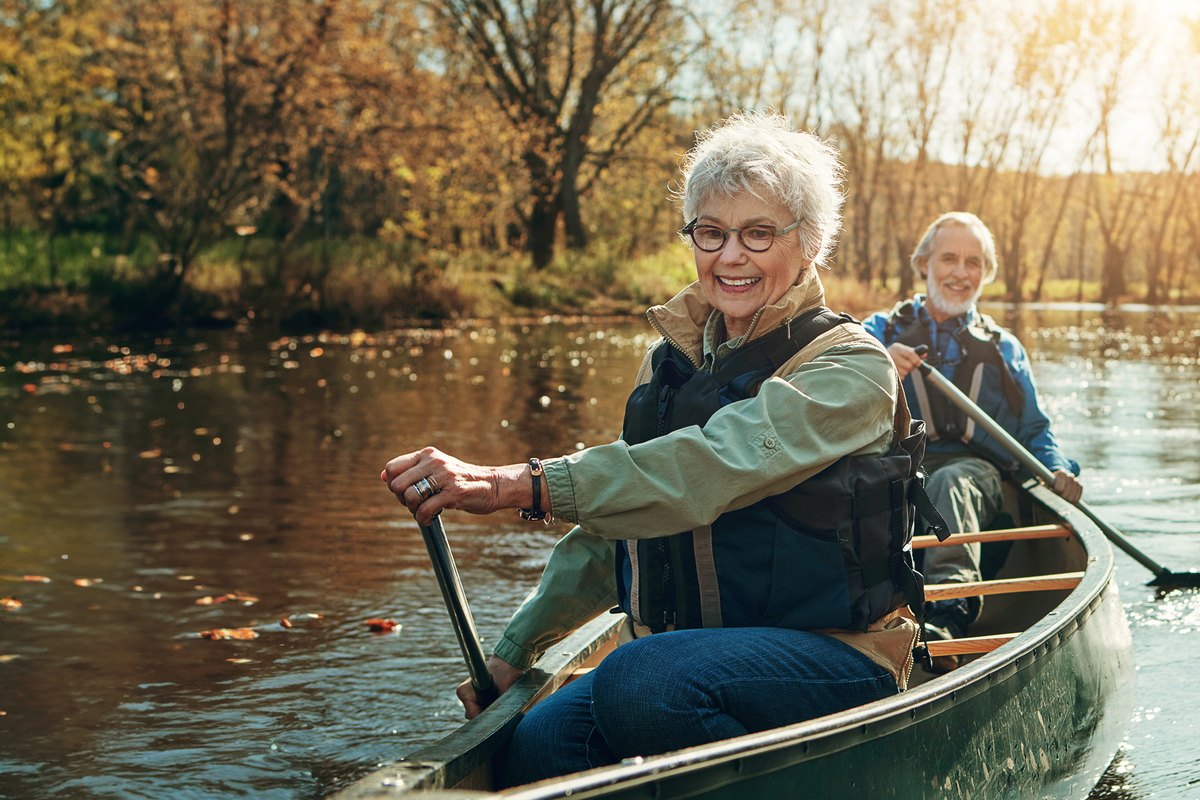 Senior woman canoeing on a calm lake