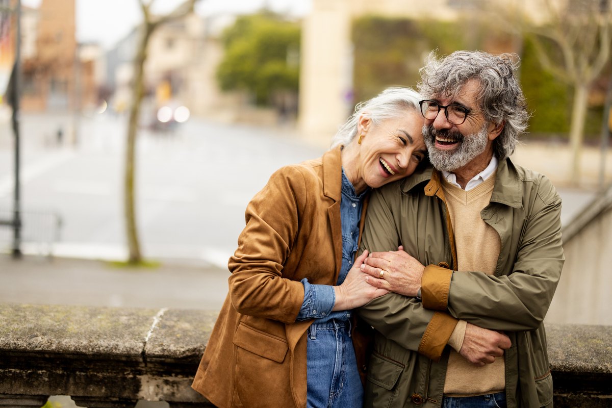 Smiling couple hugging outdoors