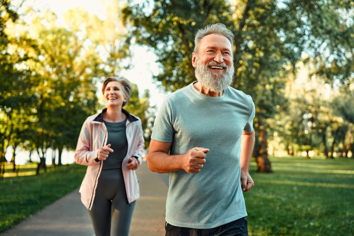Smiling couple jogging together in a park