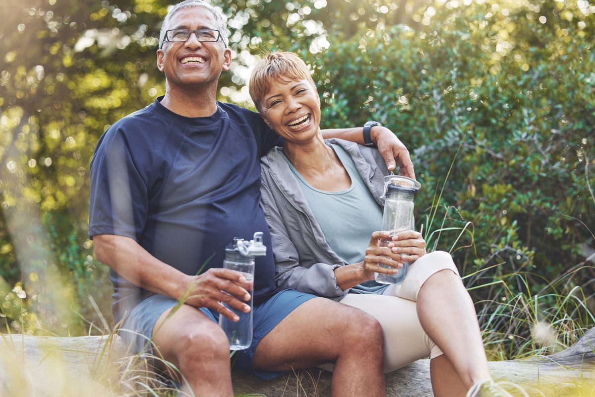 Smiling couple taking a break together after a hike