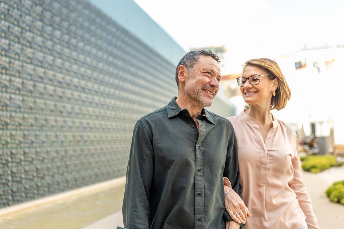 Smiling couple walking downtown