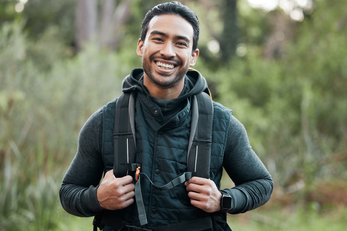 Smiling man with a hiking backpack