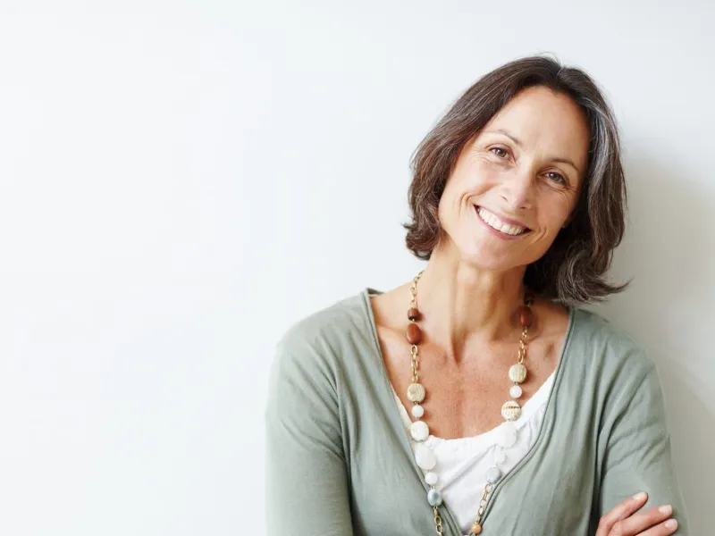 Smiling middle-aged woman with her arms crossed