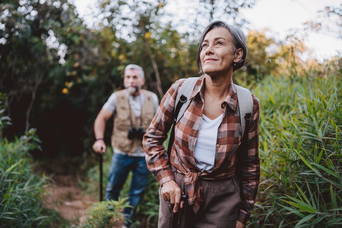 Woman hiking in the woods with her husband