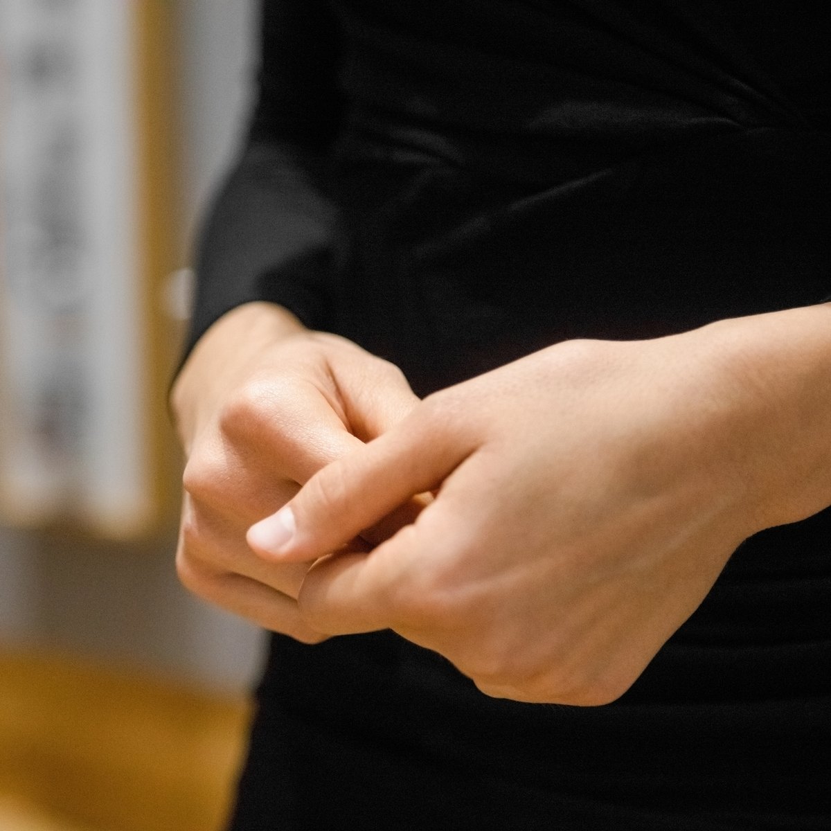 Close-up of a woman’s hands clasped together