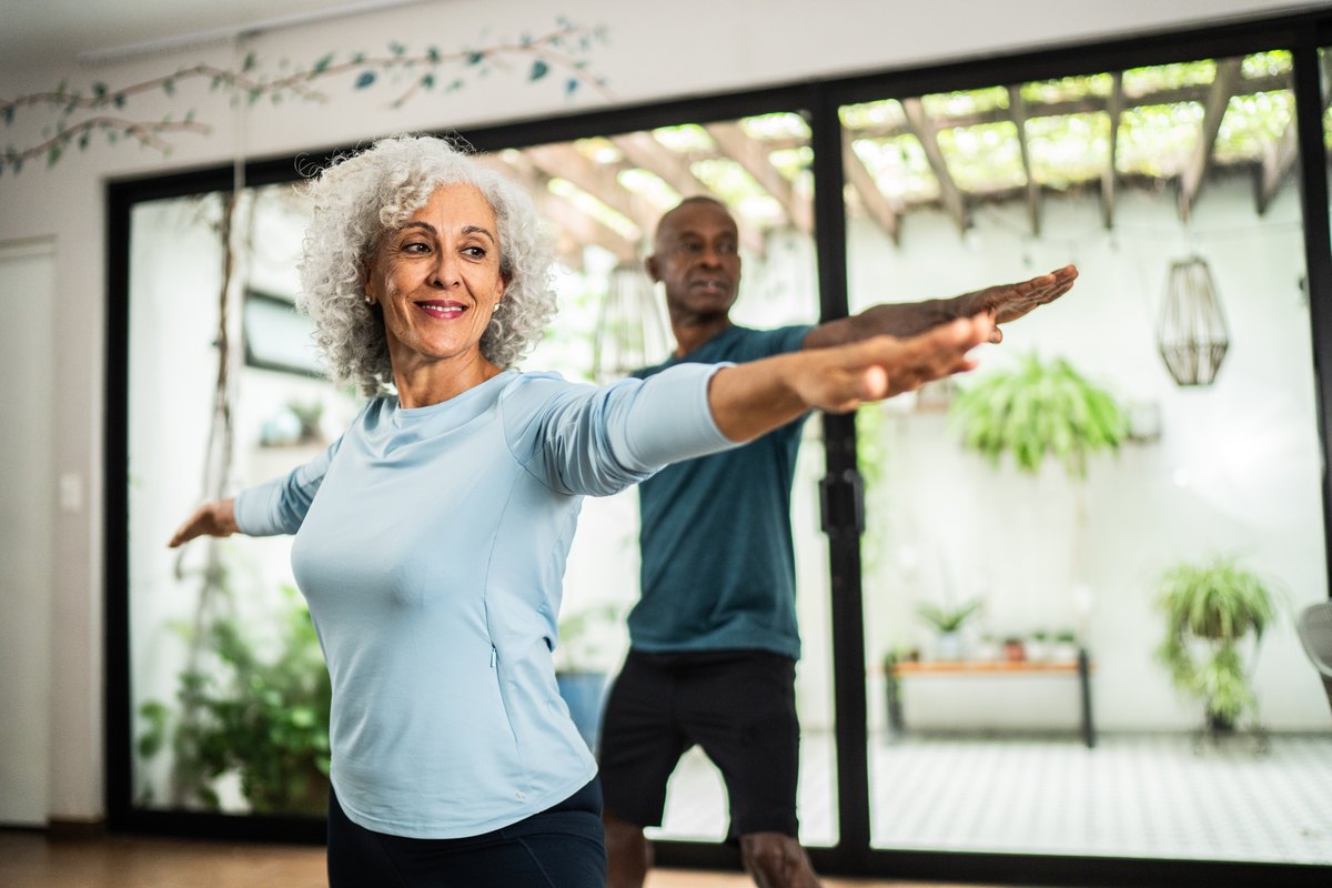 Woman stretching her arms at home
